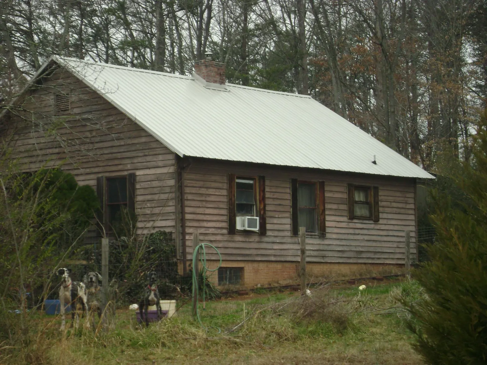 White metal roof on an old wood sided farmhouse, from a Metal Roof Installation job in West Kingston